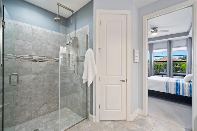 bathroom featuring a shower with door, ceiling fan, and tile patterned flooring