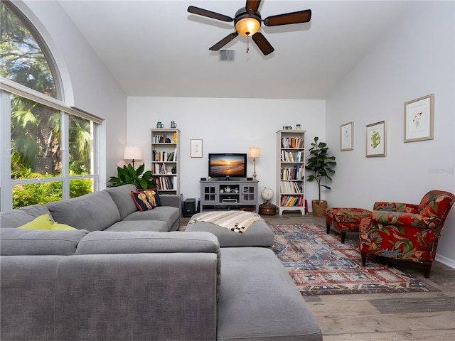 living room with hardwood / wood-style floors, ceiling fan, and lofted ceiling