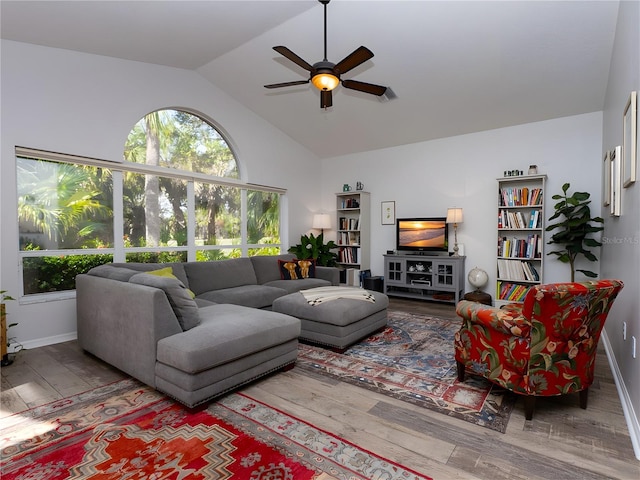 living room with wood-type flooring, vaulted ceiling, and ceiling fan