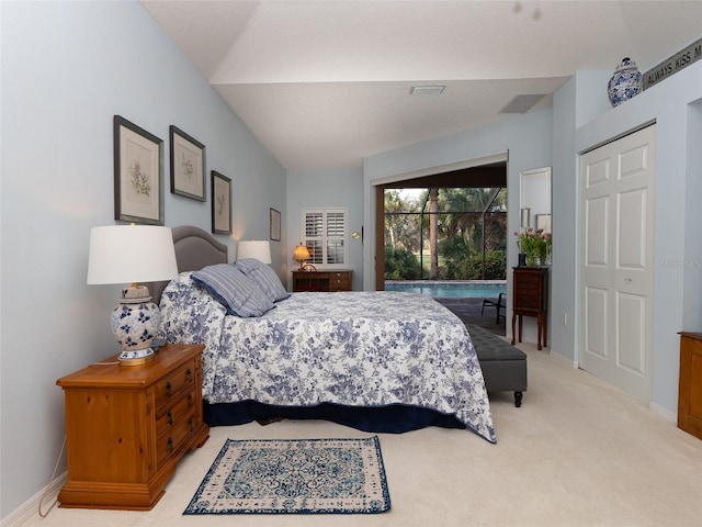 bedroom with access to outside, light colored carpet, lofted ceiling, and a closet