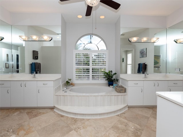 bathroom featuring a bathtub, vanity, and ceiling fan