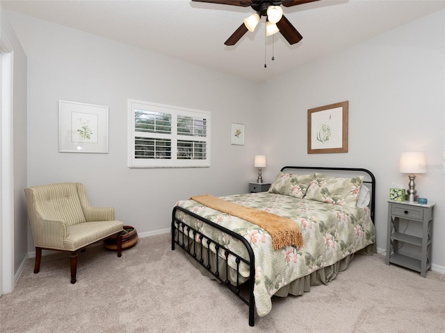 bedroom featuring ceiling fan and light carpet