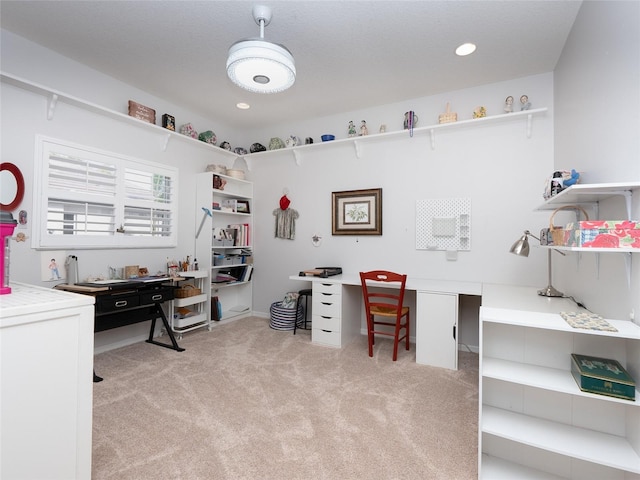 carpeted office space with built in desk