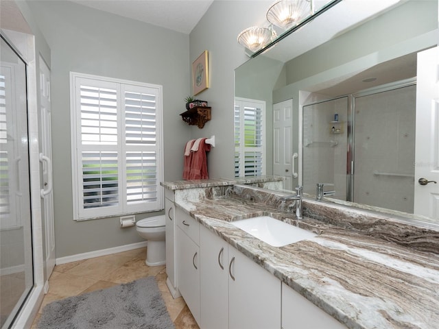 bathroom featuring a shower with shower door, vanity, toilet, and tile patterned floors