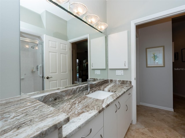 bathroom featuring vanity and a shower with shower door