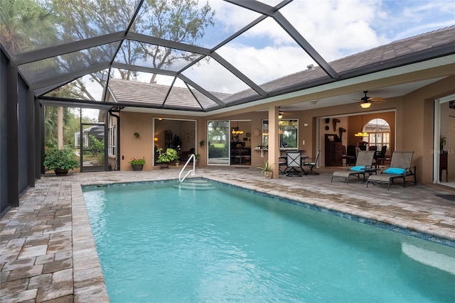 view of swimming pool with a patio area, a lanai, and ceiling fan