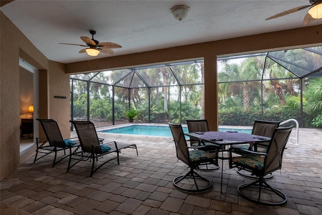 view of patio featuring a lanai and ceiling fan