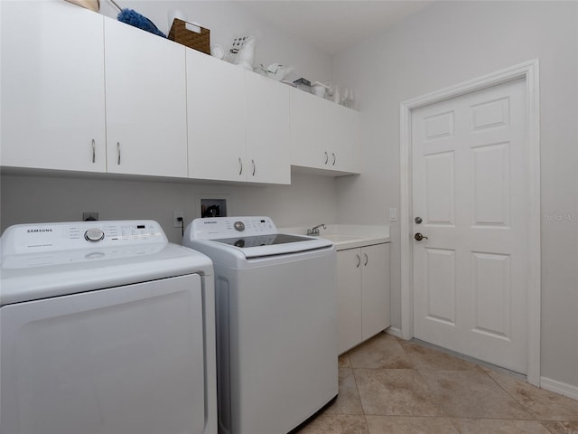 clothes washing area with cabinets, sink, independent washer and dryer, and light tile patterned flooring