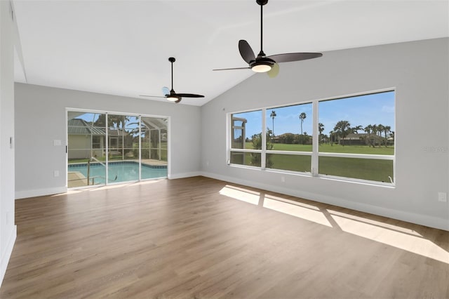 unfurnished living room featuring lofted ceiling, hardwood / wood-style flooring, and ceiling fan