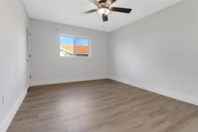 spare room featuring light hardwood / wood-style floors and ceiling fan