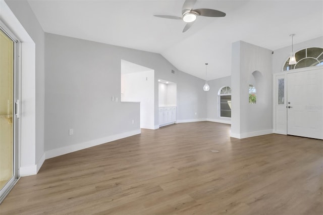 entryway with hardwood / wood-style floors, vaulted ceiling, and ceiling fan