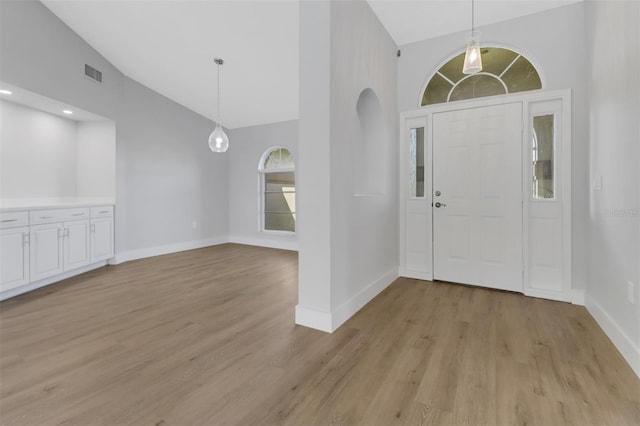 foyer featuring light hardwood / wood-style flooring and high vaulted ceiling