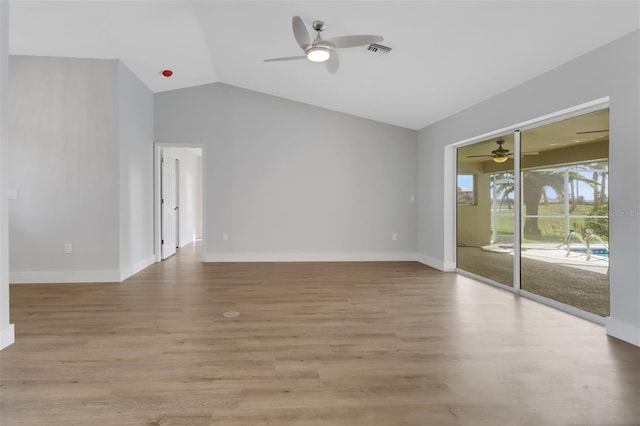 spare room featuring light wood-type flooring, lofted ceiling, and ceiling fan