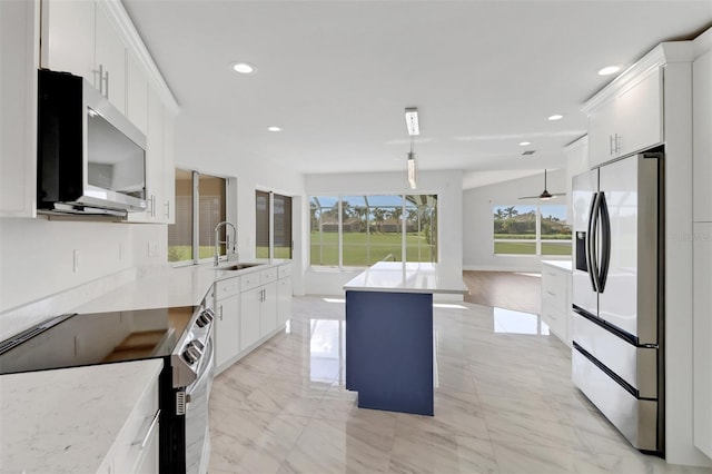 kitchen featuring white cabinetry, sink, a healthy amount of sunlight, and stainless steel appliances