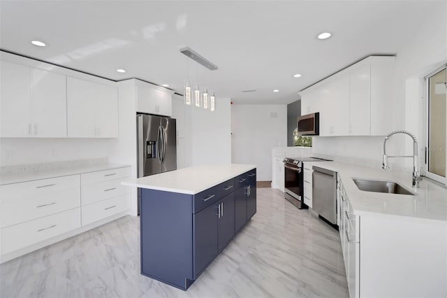 kitchen with white cabinetry, pendant lighting, sink, and stainless steel appliances