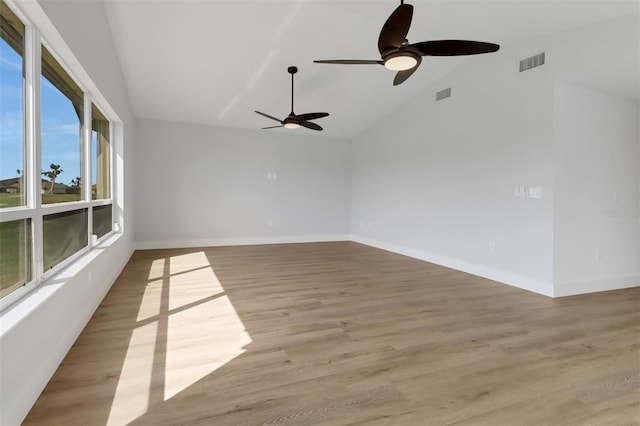 spare room with high vaulted ceiling, light hardwood / wood-style floors, and ceiling fan