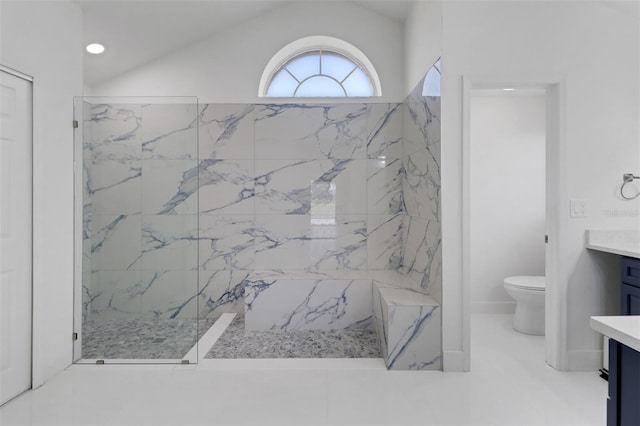 bathroom with toilet, vanity, lofted ceiling, and a tile shower