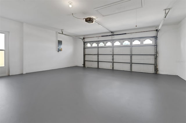 garage with electric panel and a garage door opener