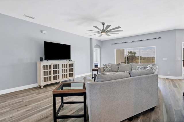 living room with light hardwood / wood-style floors and ceiling fan