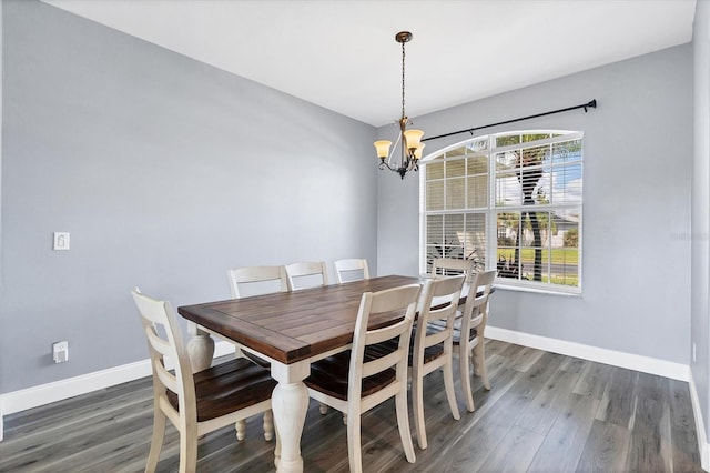 dining area with a notable chandelier and dark hardwood / wood-style floors