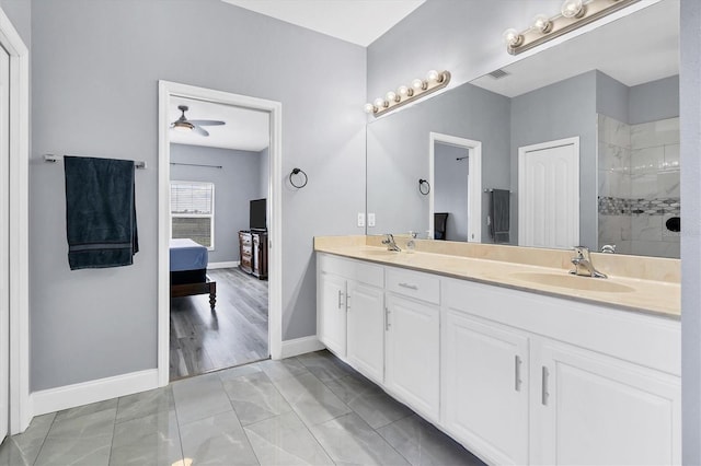 bathroom with vanity, a tile shower, ceiling fan, and hardwood / wood-style floors