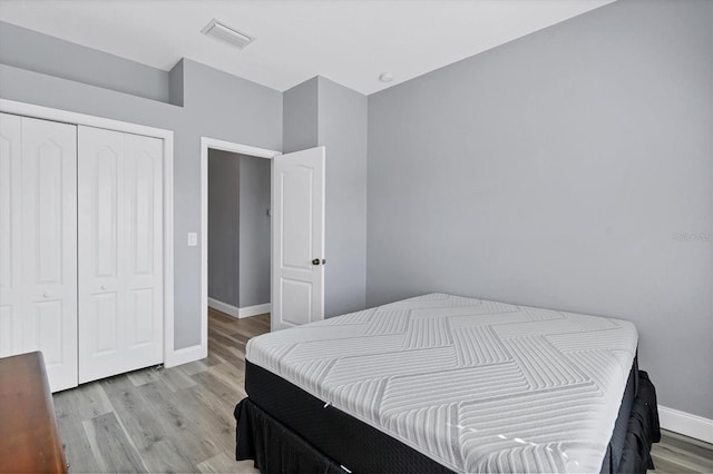 bedroom with a closet and light hardwood / wood-style flooring