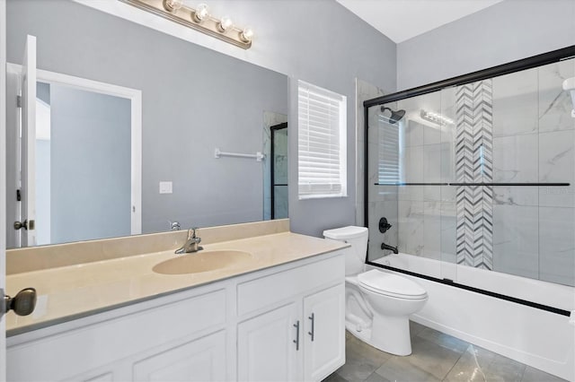 full bathroom with vanity, toilet, and bath / shower combo with glass door