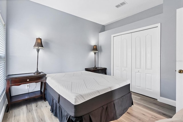 bedroom with a closet and light wood-type flooring