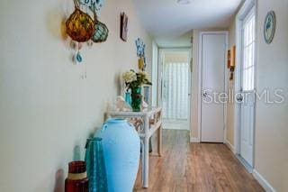 hallway with light hardwood / wood-style flooring