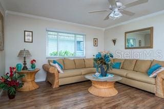 living room featuring ornamental molding, hardwood / wood-style flooring, and ceiling fan