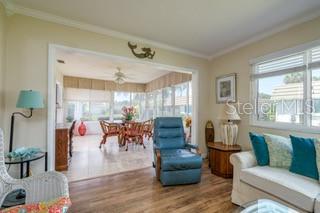 2609 Riverbluff Pkwy Unit 146, Sarasota, FL 34231 - living area featuring wood finished floors and crown molding