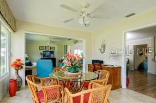 dining area with hardwood / wood-style flooring and ceiling fan