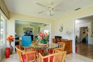 2609 Riverbluff Pkwy Unit 146, Sarasota, FL 34231 - dining space with a ceiling fan and plenty of natural light