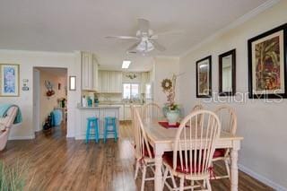 dining area with ornamental molding, hardwood / wood-style flooring, and ceiling fan