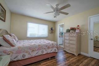 bedroom with dark wood-type flooring and ceiling fan