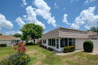 2609 Riverbluff Pkwy Unit 146, Sarasota, FL 34231 - rear view of property with a lawn