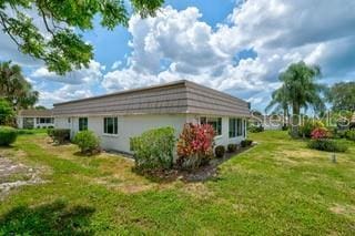 2609 Riverbluff Pkwy Unit 146, Sarasota, FL 34231 - rear view of house with a lawn
