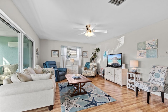 living room with light wood-type flooring and ceiling fan