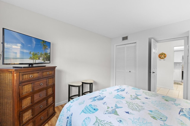 bedroom featuring a closet and light wood-type flooring