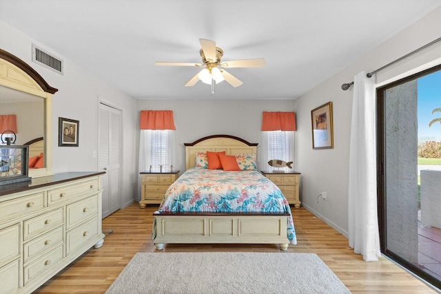 bedroom featuring light hardwood / wood-style flooring, multiple windows, ceiling fan, and access to exterior