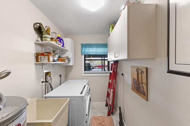 washroom featuring cabinets and separate washer and dryer