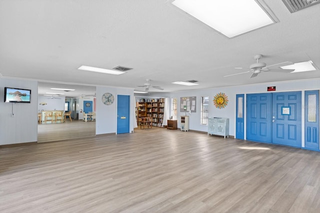 interior space featuring ornamental molding and light wood-type flooring