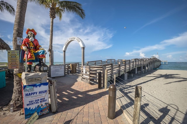 view of property's community with a water view and a beach view