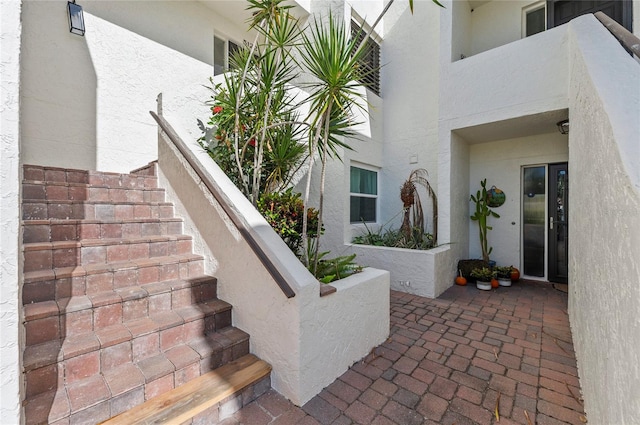 property entrance with stucco siding