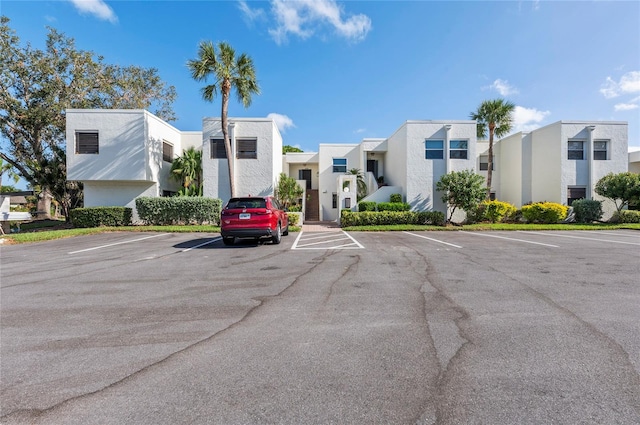 view of property featuring a residential view and uncovered parking