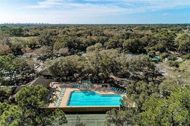 bird's eye view with a wooded view