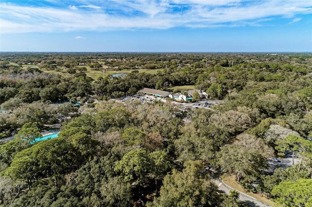 drone / aerial view featuring a wooded view