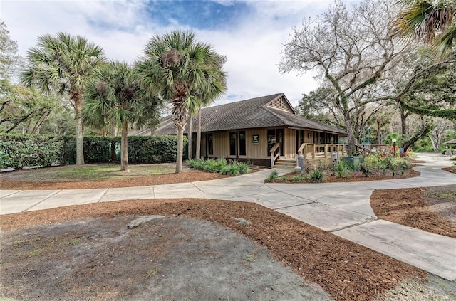 view of front facade featuring a porch and fence