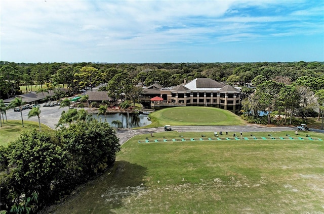 drone / aerial view with a forest view and a water view