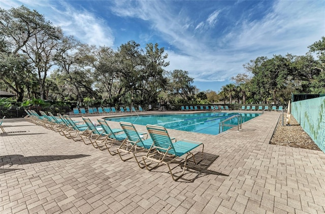 pool featuring a patio area and fence